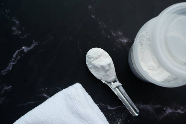 istock Washing powder in plastic spoon on black background 1443057684