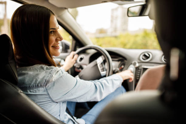 istock Girlfriends smiling at each other while starting the car to go for a fun roadtrip 1443057724