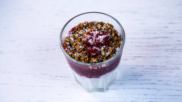 Milk and fruit smoothie with nuts and cherries. Fruit dissert with nuts and cherries in a glass cup. Fruit dissert with nuts and cherries in a glass cup. Milk and fruit smoothie with nuts and cherries. dissert stock pictures, royalty-free photos & images