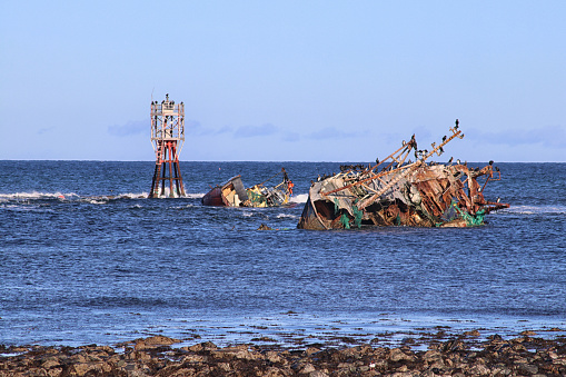 Old rusty wreck and rocky beach in Baltic Sea, natural environment. Osmussaar, Estonia, Europe.