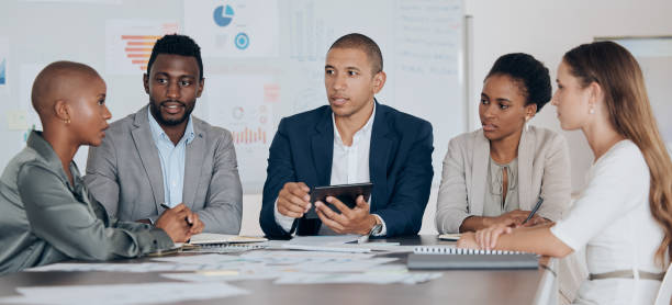 istock Leadership, planning and talking about ideas with marketing, advertising or finance team using tablet in corporate office. Business people together for collaboration, teamwork and project management 1443058396