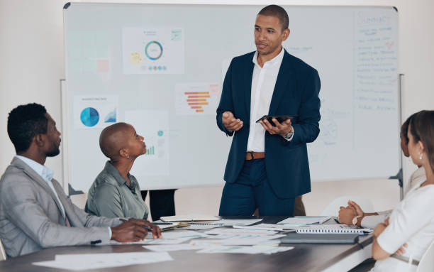 istock Corporate man leadership, tablet presentation and business meeting for analysis, workshop planning and office teamwork mentor. Manager talking, training and discussion for vision, strategy and ideas 1443058398
