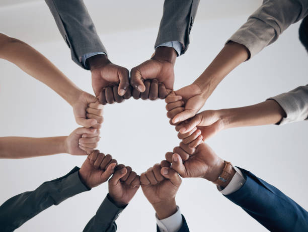 istock Team, motivation and support with hands fist bump of corporate partnership office workers. Work community, goal success and collaboration hand sign of business employee group teamwork together 1443058432