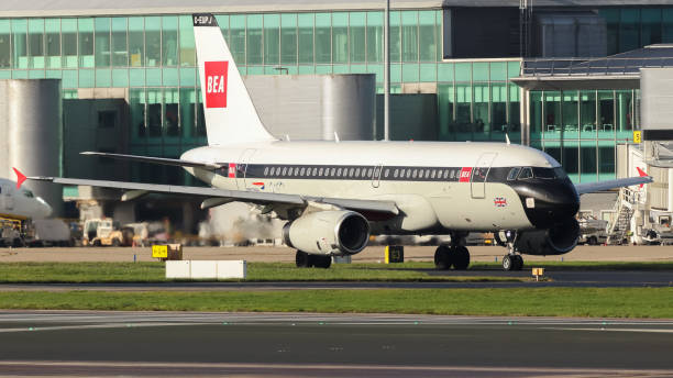 Manchester Airport, United Kingdom - 3 November, 2022: British Airways Airbus A319 (G-EUPJ BEA Retro) taxiing towards runway 23R for take off to Heathrow.