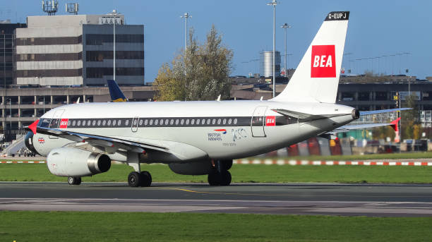 Manchester Airport, United Kingdom - 3 November, 2022: British Airways Airbus A319 (G-EUPJ BEA Retro) on runway 23R preparing for take off to Heathrow.