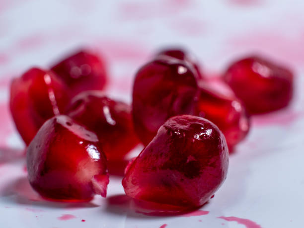 istock Ripe pomegranate. Fresh juicy pomegranate seeds on a light background. 1443061584