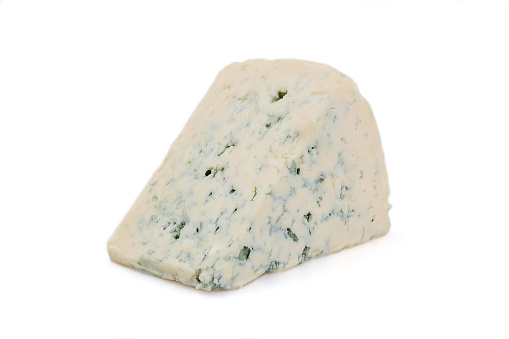 Close up of a Piece of Stilton Cheese over a wooden counter