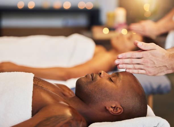 istock Hands, massage and relax with a black man customer in a spa for physical therapy or rest in a resort. Luxury, wellness and zen with a male client lying on a bed for stress relief at a lodge 1443062280