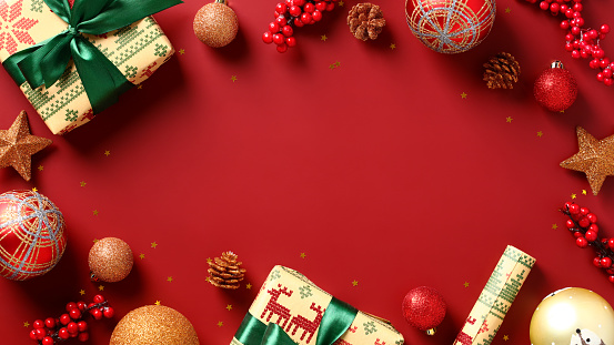 Christmas holiday red background with vintage decorations, gift boxes, baubles. Flat lay, top view.
