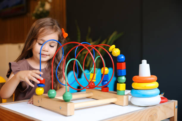 istock Portrait cute preschool age boy playing with bead puzzle 1443063587