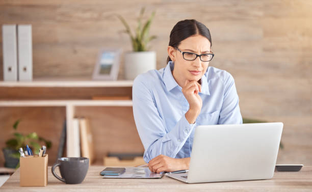 istock Thinking, solution and laptop business woman working, planning mind and strategy idea office technology. Serious, focus and expert entrepreneur reading online report, internet and question decision 1443064226