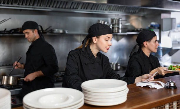istock Chef checking orders and giving out salad 1443064407