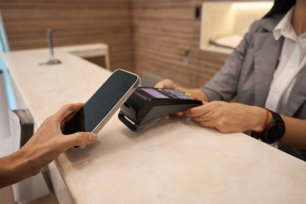 istock Close up of hand making nfc payment through contactless machine 1443070584