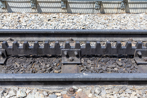 Close up selected focus on train tracks with a cog system in the middle of the tracks.