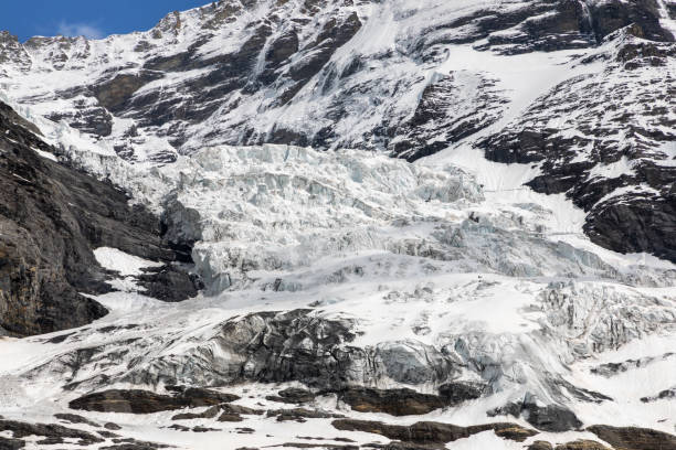 istock Glacier ice on mountain side in Swiss alps. 1443072113