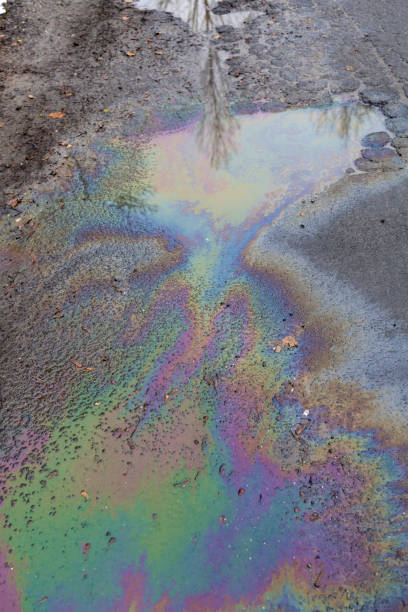 istock Oil spill on asphalt road background 1443076577