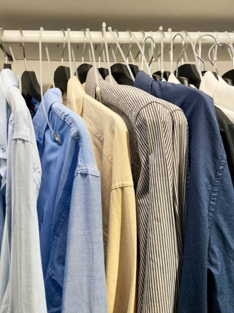 istock Clothes hanging on the coat hangers in the wardrobe 1443077603
