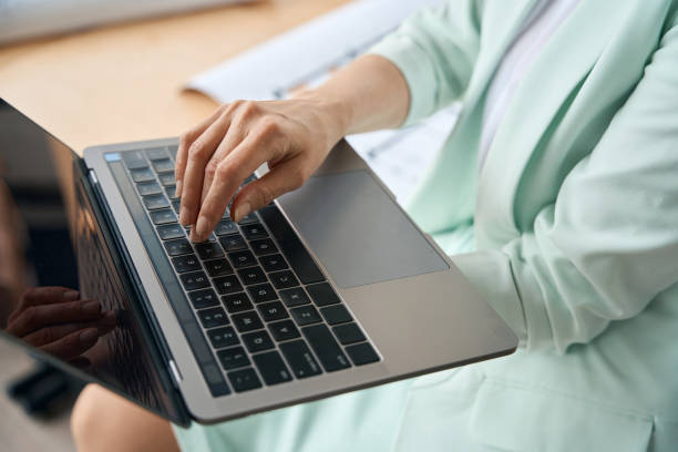 istock Well-dressed businesslady using her laptop at workplace 1443082318