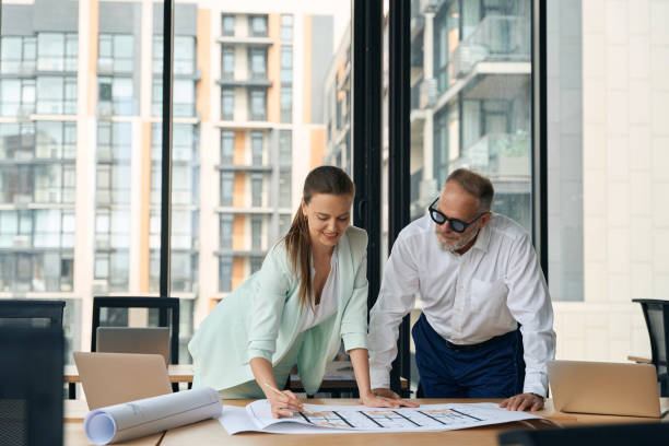 istock Successful business partners studying the charts on the office table 1443082322