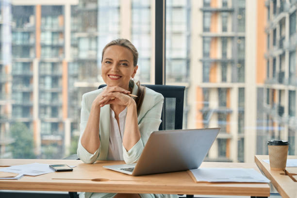 istock Admirable businesslady posing at modern office desk with laptop 1443082410