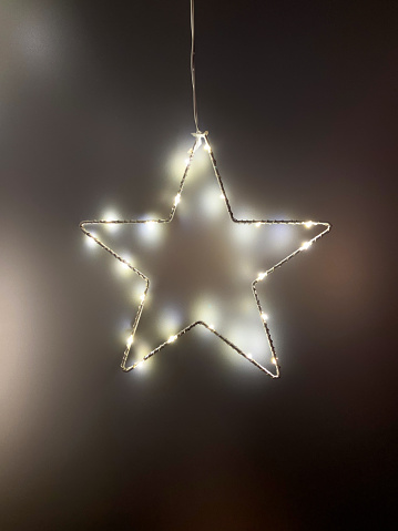 Christmas lights. Star shape led light with copy space on the dark background