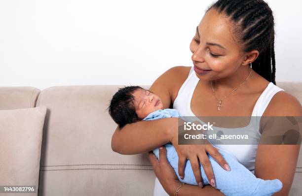 Beautiful African American Mother Holds Newborn Baby In The Living Room Stock Photo - Download Image Now