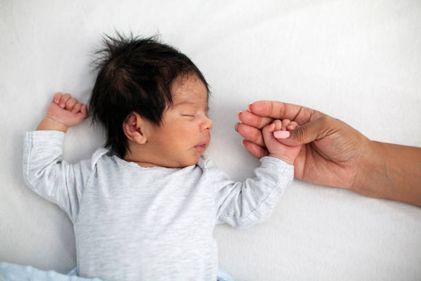 istock Newborn baby securely grasping his mother's finger 1443082875