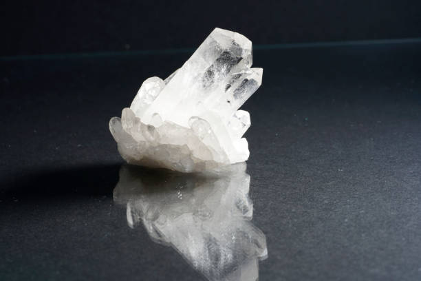 istock Quartz with mineral crystals against a black background 1443087364