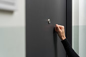 Woman hand knocking on the metal door