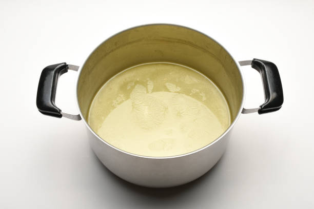 istock Chicken broth in a saucepan on the white background. Chicken broth soup 1443087913