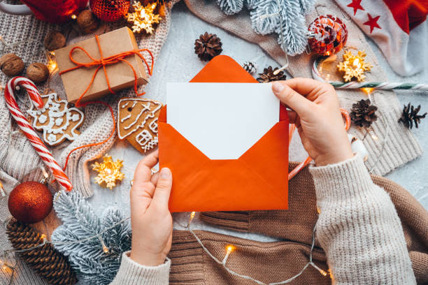istock New Year's envelope with a letter in hands with a place for your text 1443088877