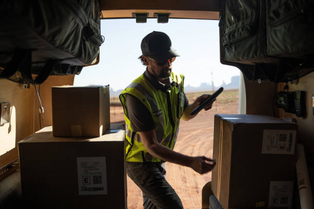 istock Delivery man checking for packages out of his van 1443089682