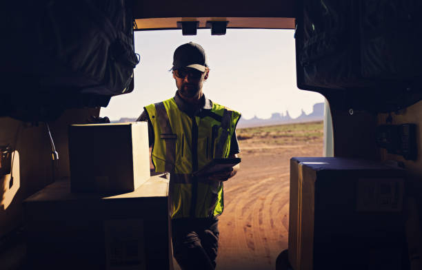 istock Delivery man checking for packages out of his van 1443090287