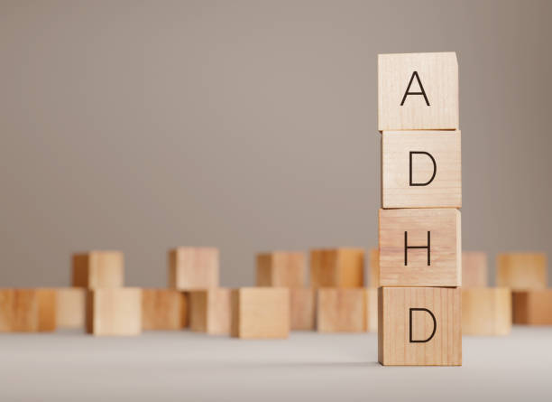 Stack of wood tile blocks with letters ADHD, 3d rendering. Psychological disorder title, mental health, adhd awareness concept