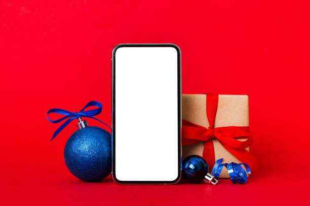 istock Digital phone mock up with rustic Christmas decorations for app presentation with empty space for you design. Christmas online shopping concept. Tablet with copy space on colored background 1443102676