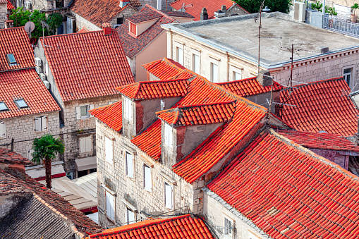 Tiled rooftops of old houses . Old town with red roofs