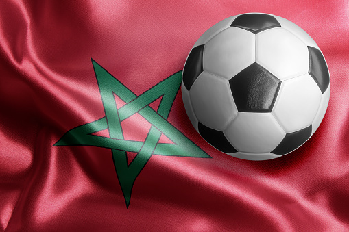 Soccer ball on flag of Morocco. Horizontal orientation. No people.