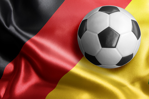 Soccer ball on flag of Germany. Horizontal orientation. No people.
