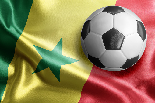 Soccer ball on flag of Senegal. Horizontal orientation. No people.