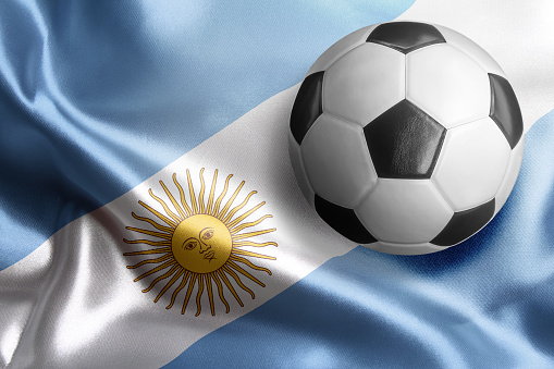 Soccer ball on flag of Argentina. Horizontal orientation. No people.