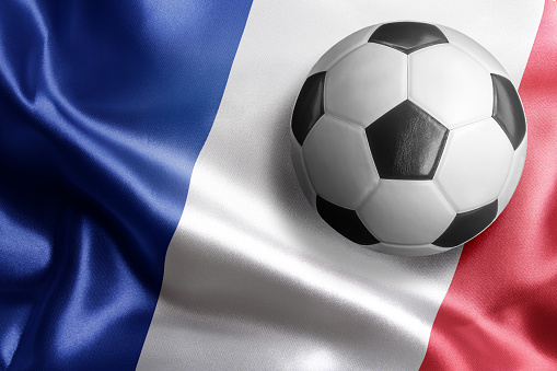 Soccer ball on flag of France. Horizontal orientation. No people.