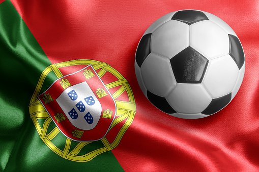 Soccer ball on flag of Portugal. Horizontal orientation. No people.