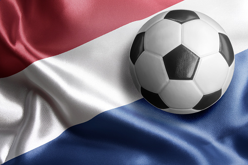 Soccer ball on flag of Netherlands. Horizontal orientation. No people.