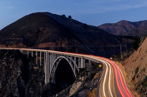 Car light trails illuminating Bixby Creek Bridge. Big Sur, California, USA.