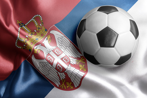 Soccer ball on flag of Serbia. Horizontal orientation. No people.