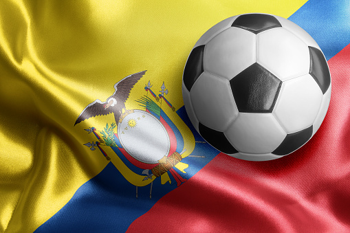 Soccer ball on flag of Ecuador. Horizontal orientation. No people.