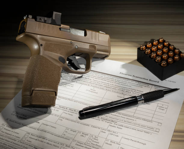 istock Gun and cartridges with form for a firearm purchase 1443103896