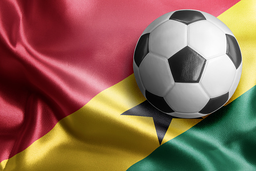 Soccer ball on flag of Ghana. Horizontal orientation. No people.