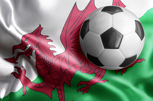 Soccer ball on flag of Wales. Horizontal orientation. No people.