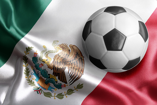 Soccer ball on flag of Mexico. Horizontal orientation. No people.